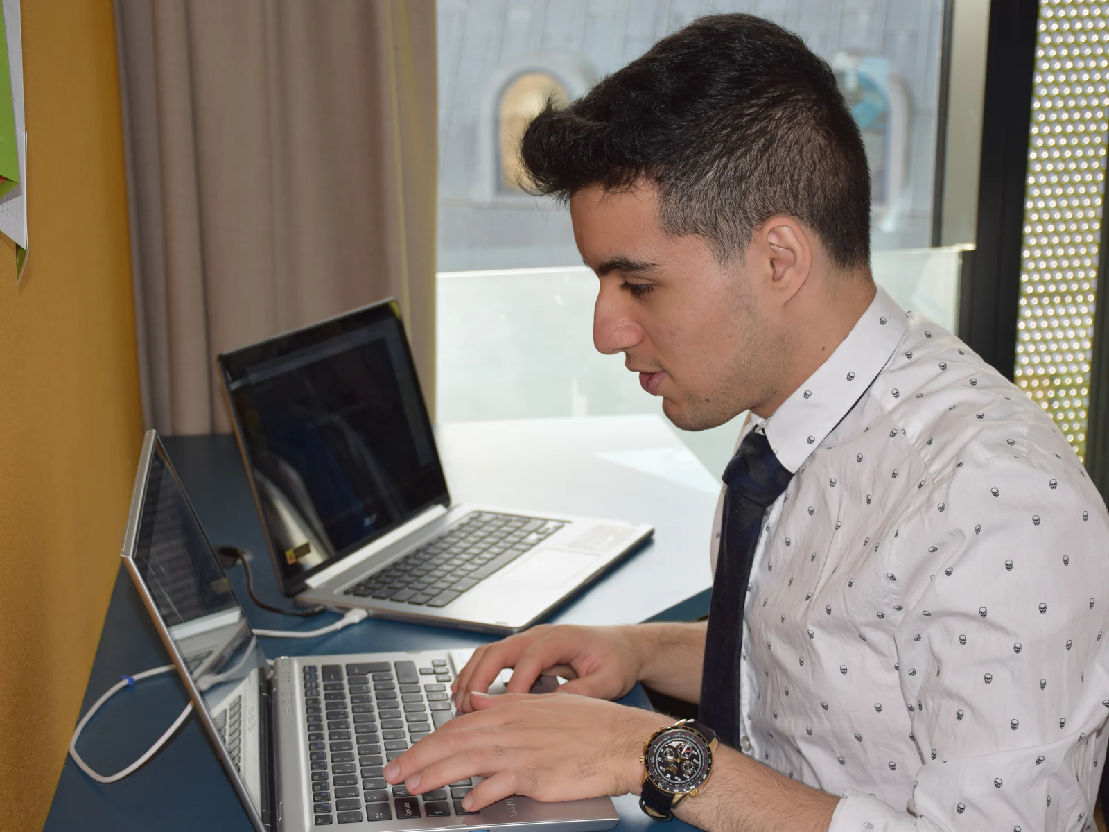 Madyan building his first SaaS on two laptops at university in 2017